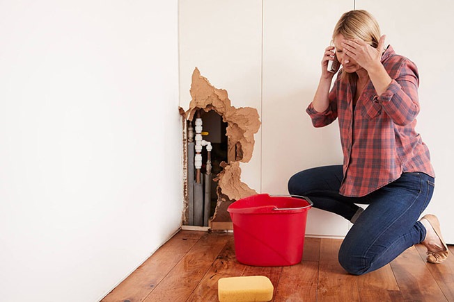 https://handymanconnection.com/wp-content/uploads/2021/05/bigstock-Middle-aged-woman-with-a-burst-215212882.jpg
