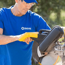 craftsmen using power saw to provide carpentry services